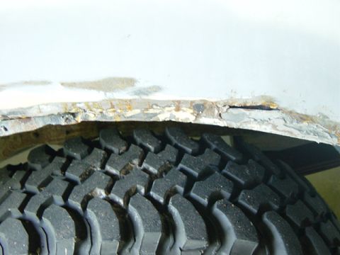 1993 Ford Bronco - The wheel well shows significant rust damage and is partially obscured by the tire.