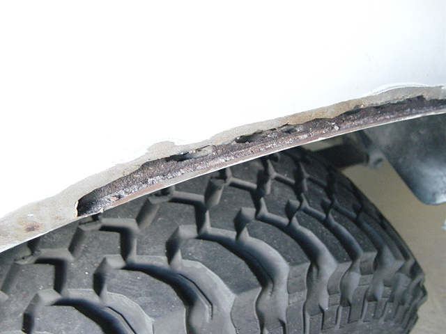 1993 Ford Bronco wheel well edge showing rust damage above tire