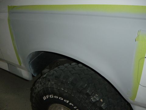 1993 Ford Bronco - A close-up of a vehicle's fender and tire, prepared for bodywork, suggests a 1992 model year.