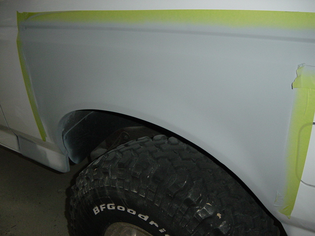 White vehicle fender with masking tape, showing a BFGoodrich tire. Appears to be a 1992 Ford Bronco