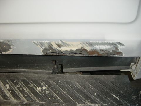 1993 Ford Bronco - The rocker panel of a 1993 Ford Bronco shows signs of rust and repair work.