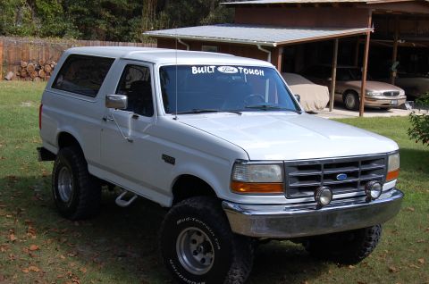 1993 Ford Bronco - White 1993 Ford Bronco with "Built Ford Tough" decal on windshield.