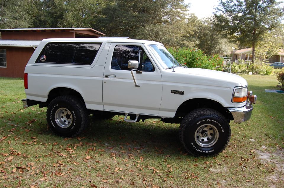 White 1993 Ford Bronco side profile with aftermarket wheels