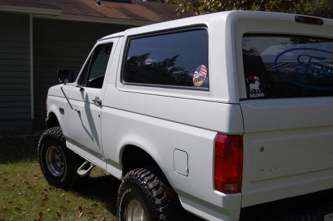 1993 Ford Bronco - This 1993 Ford Bronco features a lifted suspension and aggressive off-road tires, seen here from a rear three-quarter perspective.