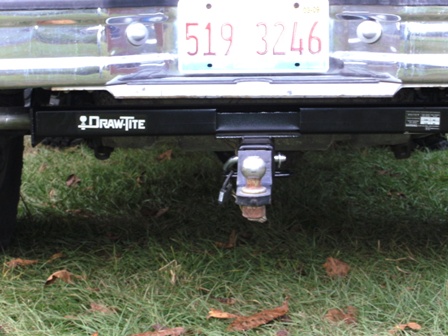 1993 Ford Bronco - The rear of a vehicle shows a Draw-Tite hitch receiver and a license plate with the number 519 3246.