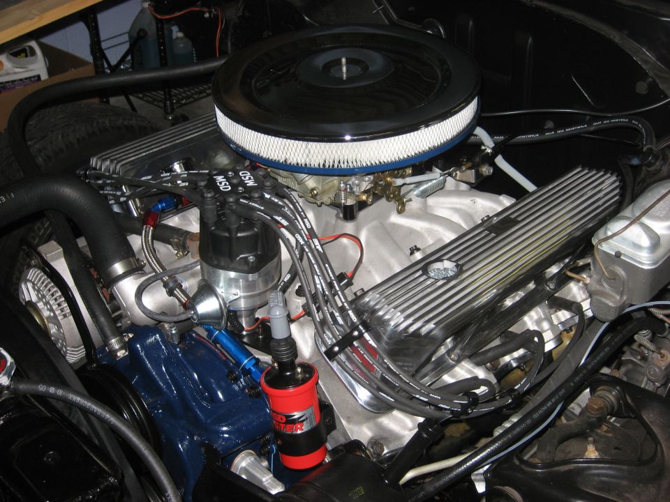 V8 engine close-up with chrome air cleaner, aluminum intake, finned valve covers and MSD distributor