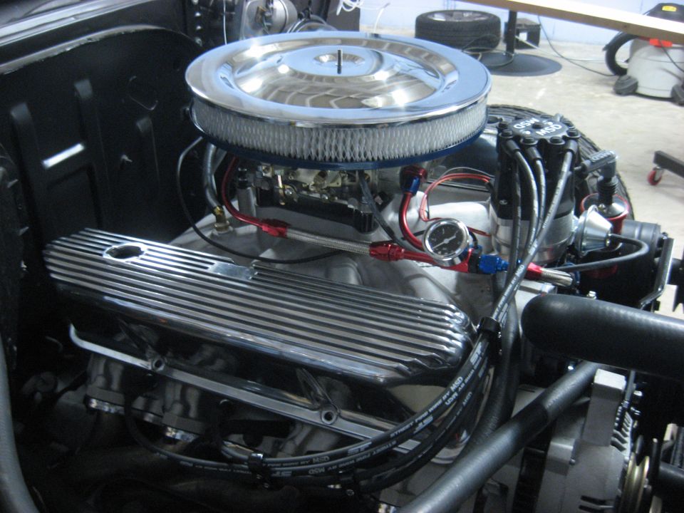 V8 engine bay with chrome air cleaner, finned valve cover, braided fuel line and AN fittings