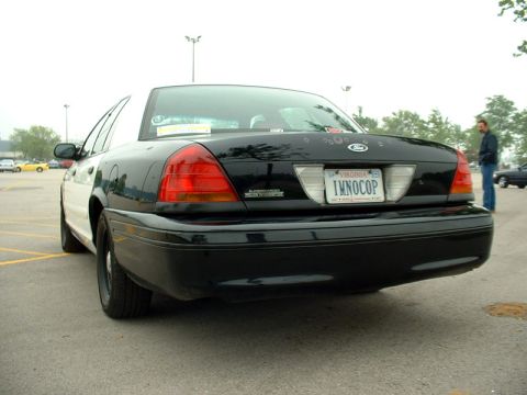 2000 Ford Crown Victoria - This 2000 Ford Crown Victoria police car is seen from the rear in a parking lot. The Virginia license plate reads 'IMNOCOP'.