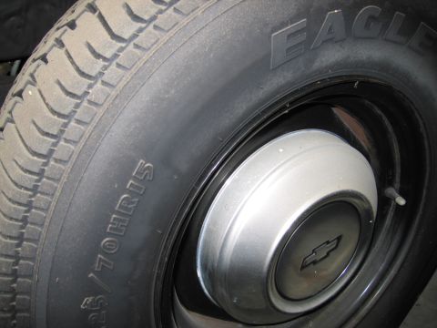 1991 Ford LTD Crown Victoria - Photograph of a Goodyear Eagle tire and Chevrolet hubcap, not a technical document.