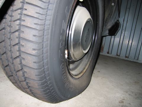 1991 Ford LTD Crown Victoria - Photograph of a rear wheel with Goodyear tire and hubcap, not a technical document.