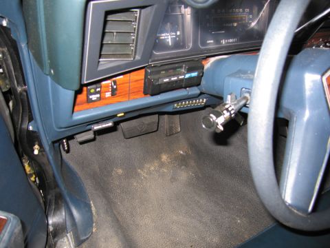1991 Ford LTD Crown Victoria - Photograph of the lower dashboard and steering column of a vehicle interior, not a technical document.