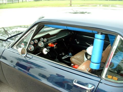 2000 Ford Crown Victoria - This car's interior features a roll cage and numerous gauges, with a sticker on the window reading 'Loud Pipes Save Lives'.