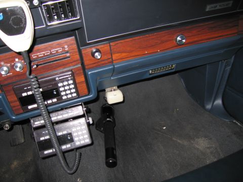1991 Ford LTD Crown Victoria - Interior photo of a vehicle dash fitted with a Motorola two-way radio and handset, not a document.