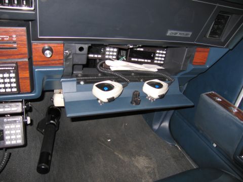 1991 Ford LTD Crown Victoria - Photo of vehicle interior showing aftermarket radio control heads under the dash, not a document.