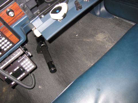 1991 Ford LTD Crown Victoria - Interior photo of a vehicle footwell and dash-mounted radio gear, not a document.