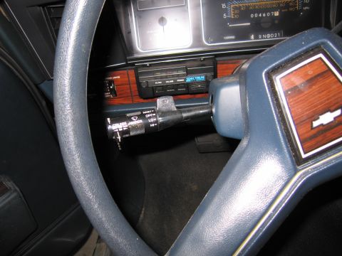 1991 Ford LTD Crown Victoria - Interior photo of a steering wheel, gauge cluster and shifter, not a document.