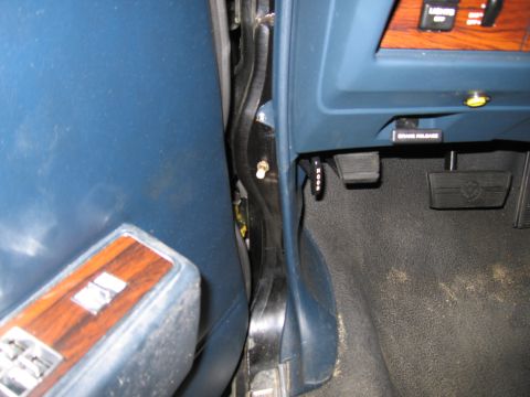 1991 Ford LTD Crown Victoria - Interior view of a car's door jamb, focusing on the seatbelt mechanism and adjacent panel.