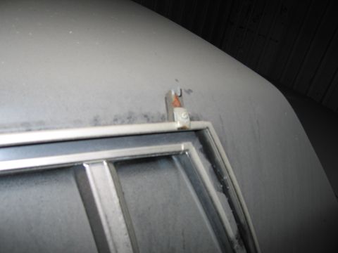 1991 Ford LTD Crown Victoria - Dust covers the roof trim and antenna base of a vehicle, obscuring its details.