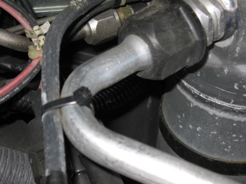 1991 Ford LTD Crown Victoria - Photo of engine-bay hoses and fittings, not a document.