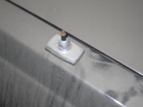 1991 Ford LTD Crown Victoria - Photo of an antenna mount on a car body, not a document.