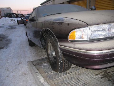 1991 Ford LTD Crown Victoria - Photograph of the front corner of a Chevrolet Caprice on a flatbed, not a technical document.