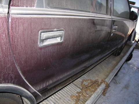 1991 Ford LTD Crown Victoria - Photograph of a vehicle's door side and handles, not a technical document.