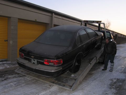 1991 Ford LTD Crown Victoria - Photograph of a Chevrolet Caprice on a flatbed tow truck, not a technical document.