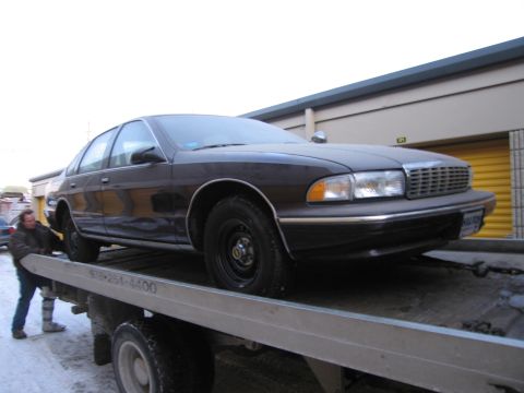 1991 Ford LTD Crown Victoria - Photograph of a Chevrolet Caprice on a flatbed tow truck, not a technical document.