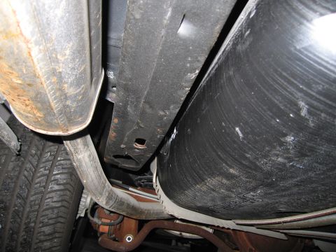 1991 Ford LTD Crown Victoria - Photograph of a vehicle undercarriage with fuel tank and frame, not a technical document.