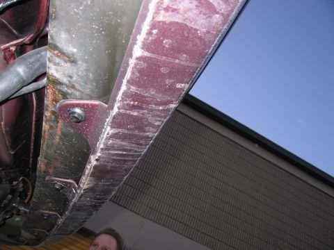 1991 Ford LTD Crown Victoria - Photograph of a vehicle underbody panel from below, not a technical document.