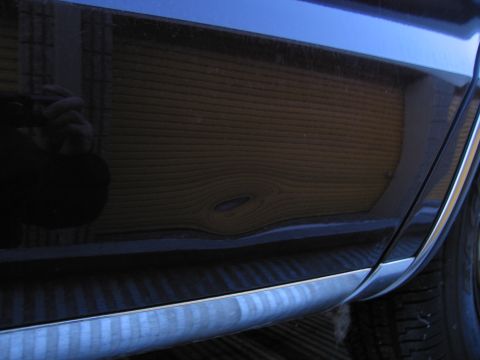 1991 Ford LTD Crown Victoria - Photograph of a car's woodgrain side panel, not a technical document.