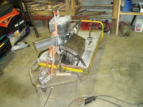 2000 Ford E350 - A custom-built vehicle chassis with a snowmobile engine and track is in a workshop setting. The chassis is yellow and silver, with orange m…