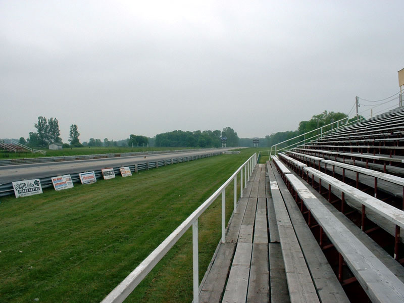 Drag strip with bleachers and signs along the track