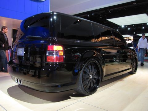 1996 Ford Probe - A black Ford Flex concept vehicle is displayed on a light-colored floor at an auto show. The rear passenger side of the vehicle is shown wi…