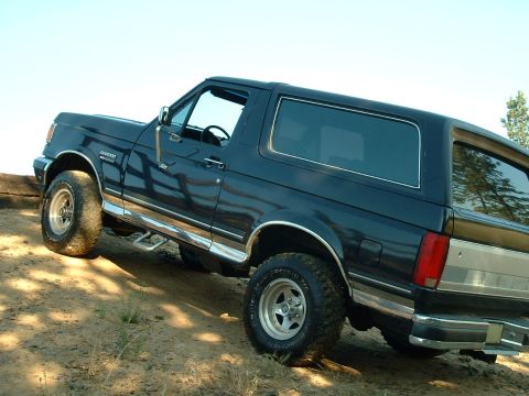 1991 Ford Bronco - This 1991 Ford Bronco is captured in a 3/4 front view as it sits on a dirt incline.