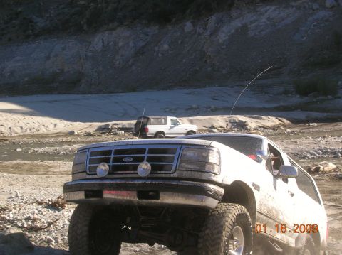 1985 Ford Bronco - This vehicle appears to be modified for off-road use, with large tires and a lifted suspension.