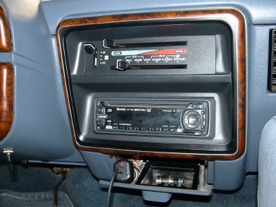 1991 Ford Bronco - Close-up of a car's dashboard showing the climate controls and an aftermarket stereo system.