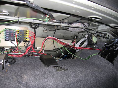 1991 Ford LTD Crown Victoria - Photograph of installed wiring and a relay panel in a vehicle trunk, not a wiring diagram.