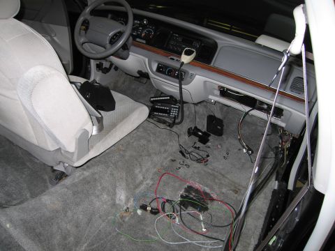1991 Ford LTD Crown Victoria - The interior of a car shows exposed wiring and a CB radio, suggesting recent work or modifications.