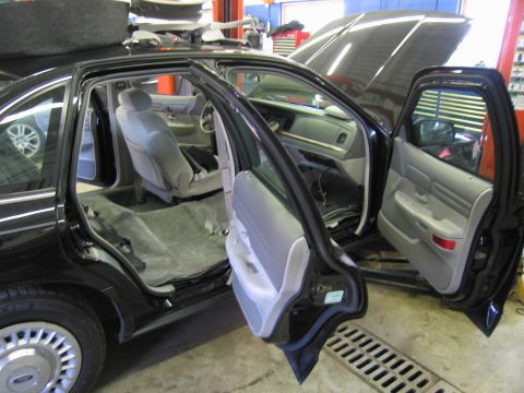 1991 Ford LTD Crown Victoria - Interior of a black Ford Crown Victoria is disassembled, revealing the seats and carpeting.