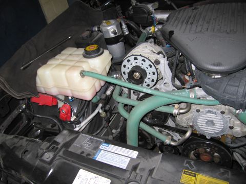 1991 Ford LTD Crown Victoria - Close-up view of a vehicle's engine bay, showing various components and hoses.