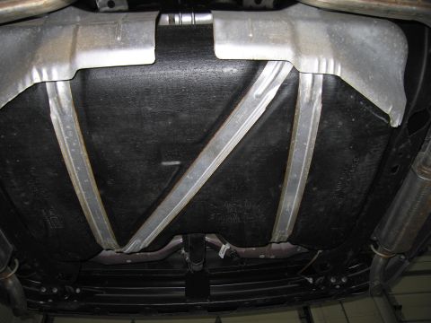 1991 Ford LTD Crown Victoria - The underside of a vehicle, focusing on the fuel tank and exhaust system, with no visible year-identifying features.