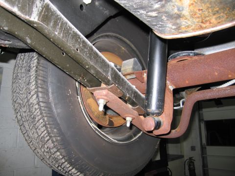 1991 Ford LTD Crown Victoria - Close-up view of the undercarriage of a vehicle, focusing on the rear suspension and tire assembly.