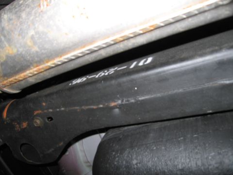 1991 Ford LTD Crown Victoria - Close-up of an underbody suspension component showing white markings that read '96-62-10'.