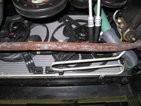 1991 Ford LTD Crown Victoria - Underside view of the engine's cooling system components, including the radiator and fans.
