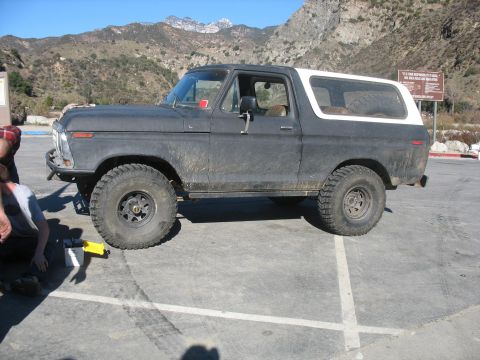 1987 Ford Bronco - This 1978 Ford Bronco is seen from the side in a parking lot with mountains in the background.