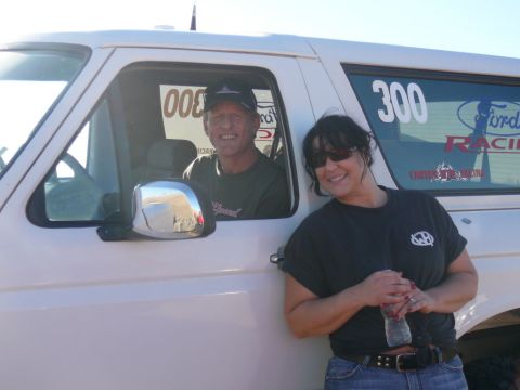 1988 Ford Bronco - A man smiles from the driver's seat of a white Ford Bronco, while a woman stands next to the vehicle holding a water bottle. The Bronco has…