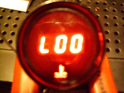 1972 Ford Ranchero - A close-up shot of a red digital display showing the text "LOO" and a symbol that resembles a "T". The display is mounted on a textured, da…