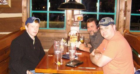 2007 Ford Mustang - Snapshot of people at a restaurant table, not a technical document.