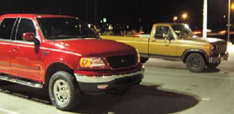 2007 Ford Mustang - Photograph of two Ford pickup trucks parked at night, not a document.